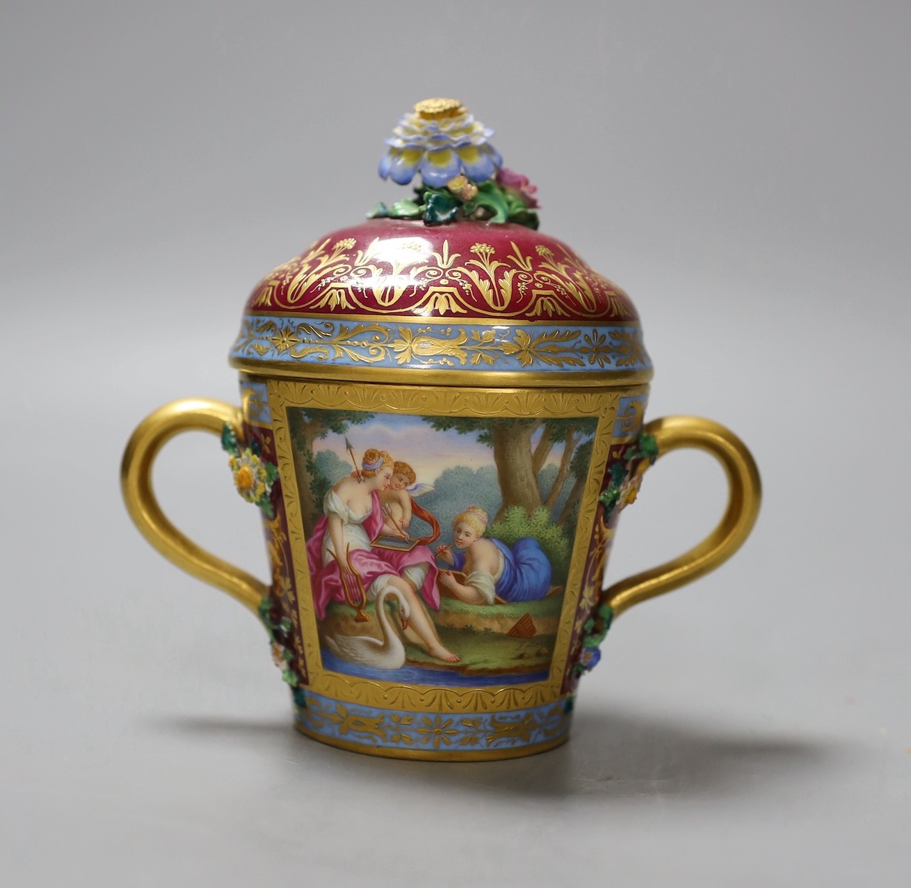 A Vienna style two handled porcelain chocolate cup and cover, c.1900, 13cms high